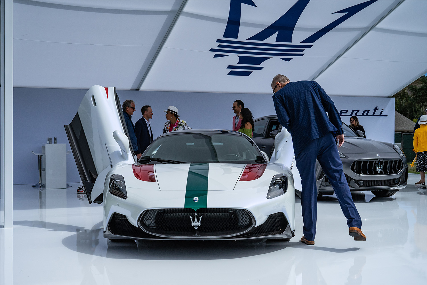 Spectator looks inside a Maserati at the Rolex Monterey Motorsports Reunion