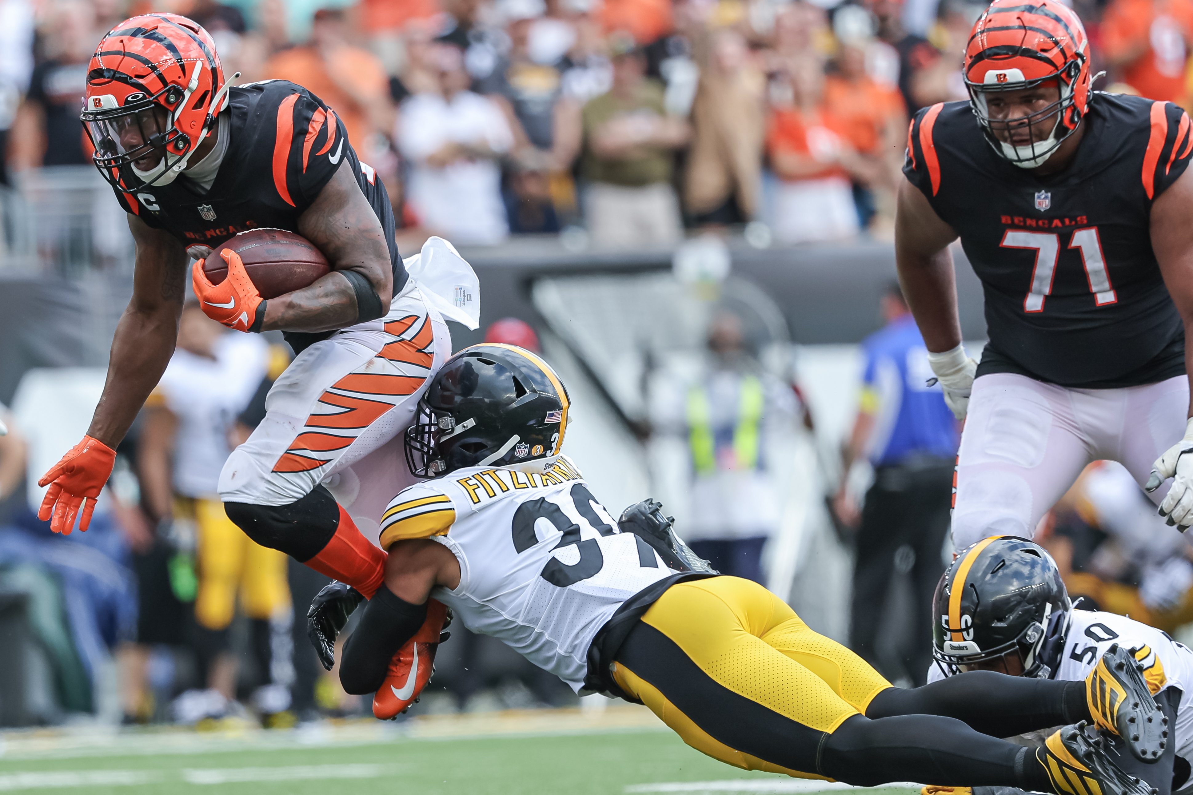 Joe Mixon of the Bengals runs the ball against Minkah Fitzpatrick of the Pittsburgh Steelers.