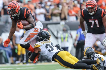 Joe Mixon of the Bengals runs the ball against Minkah Fitzpatrick of the Pittsburgh Steelers.