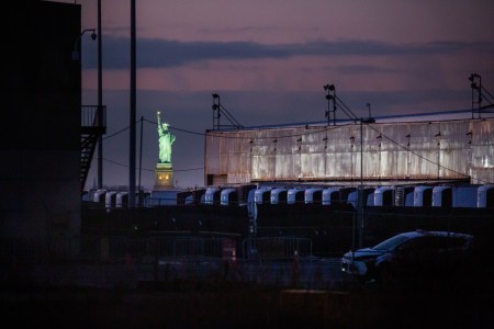 A shot of the frozen COVID morgues in New York City, with the Statue of Liberty glowing in the background.
