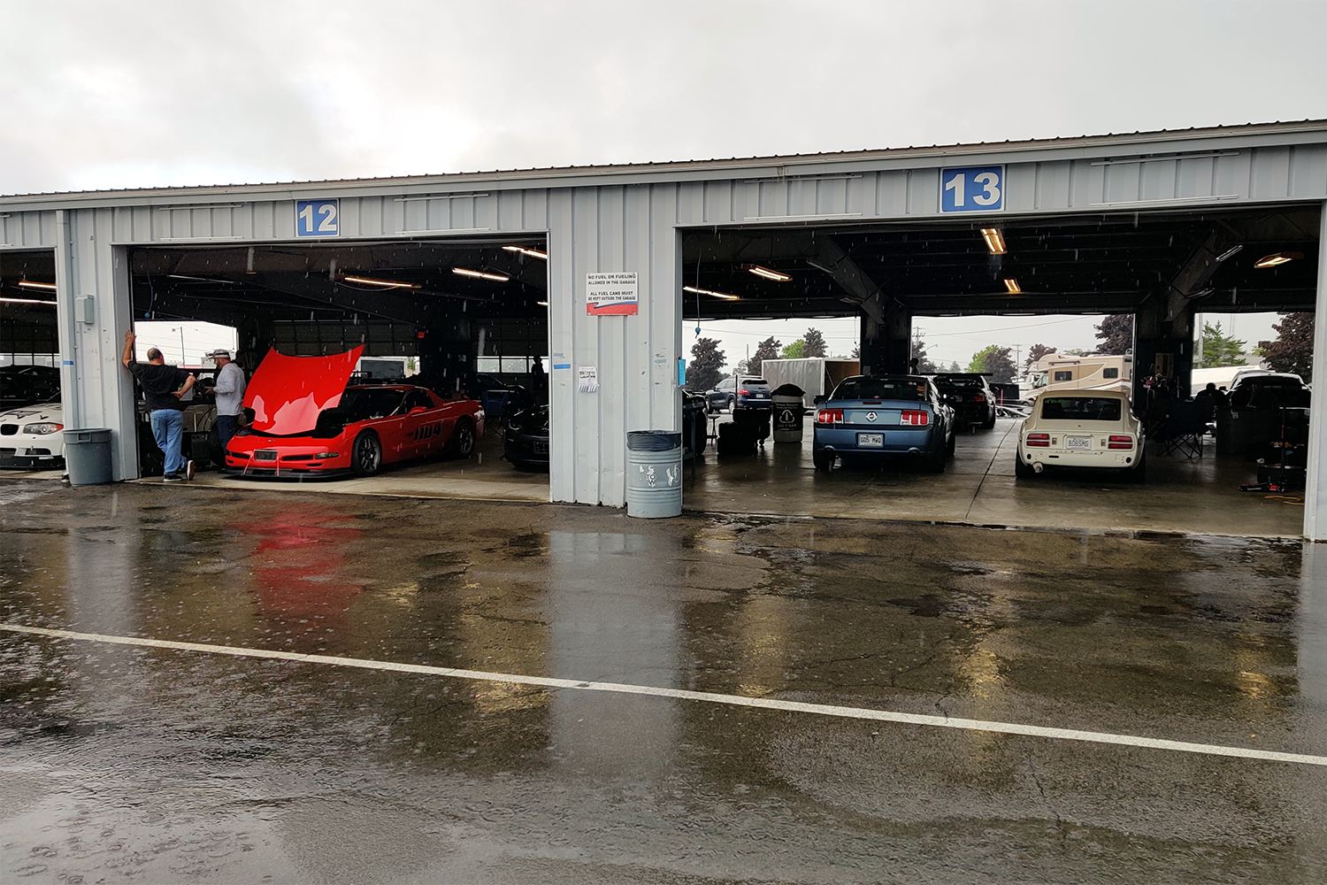 Pouring rain at Watkins Glen racetrack keeps drivers and their cars under shelter for a period of time