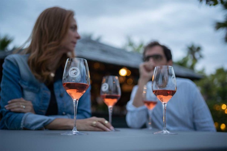 A shot of two people at a table at night drinking Cerasuolo wine