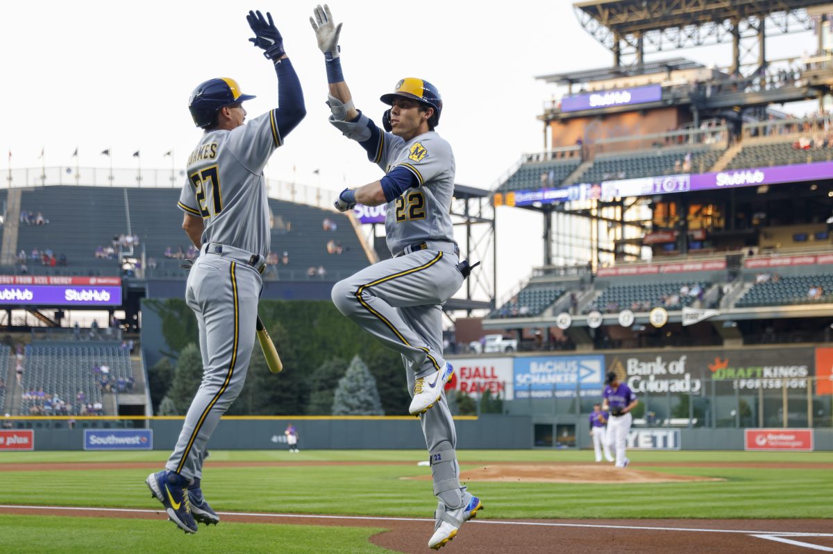 Christian Yelich (#22) celebrates his 499-foot solo home run with Willy Adames (#27).