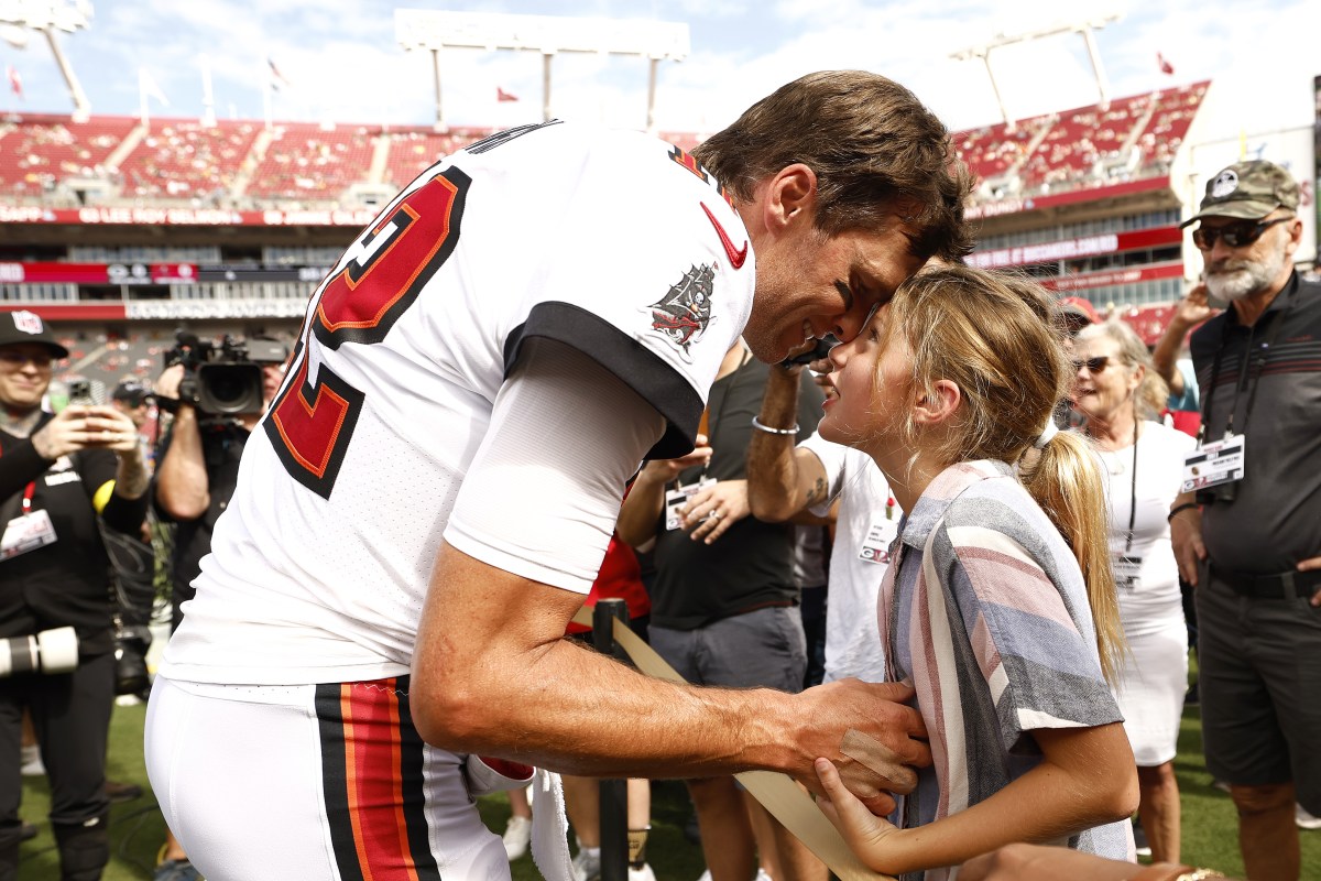 Tampa Bay Buccaneers quarterback Tom Brady hugs his daughter Vivian after a game.