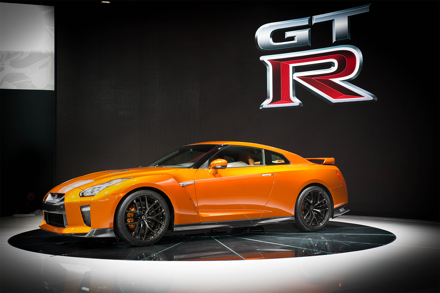 The 2017 Nissan GT-R R35 in orange on stage at the 2016 New York International Auto Show