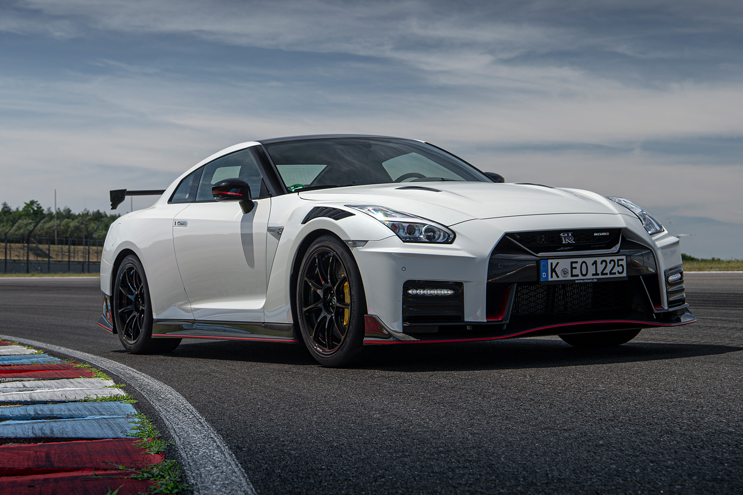 A white 2020 Nissan GT-R NISMO driving around a track
