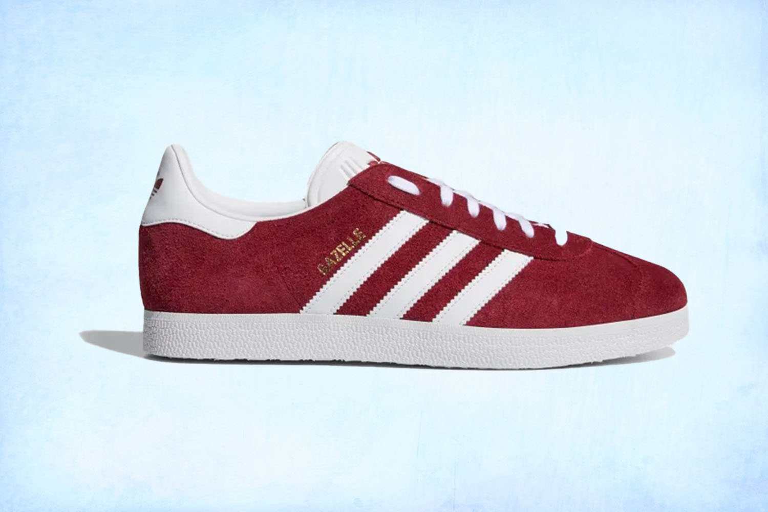 a red Adidas Gazelle sneaker on a light blue background
