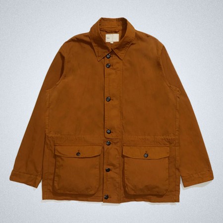 A brown M97 Button Jacket from Adsum on a grey background