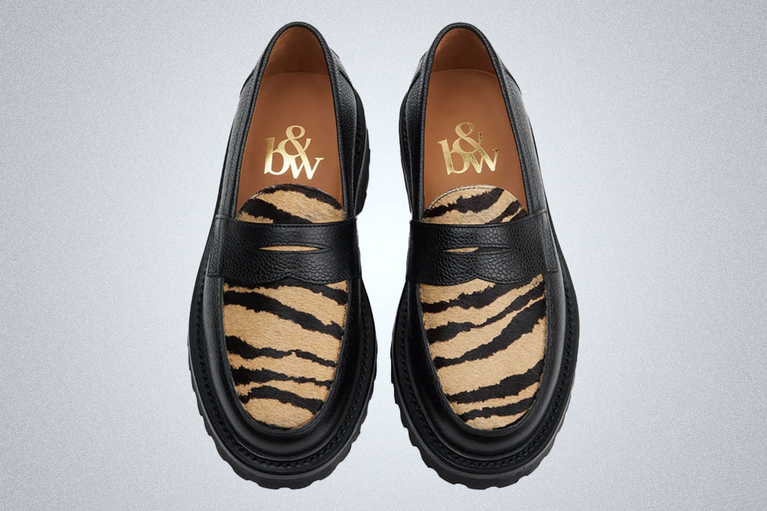 an above shot of a pair of tiger camo print black lug sole loafers from Blackstock & Weber on a grey background