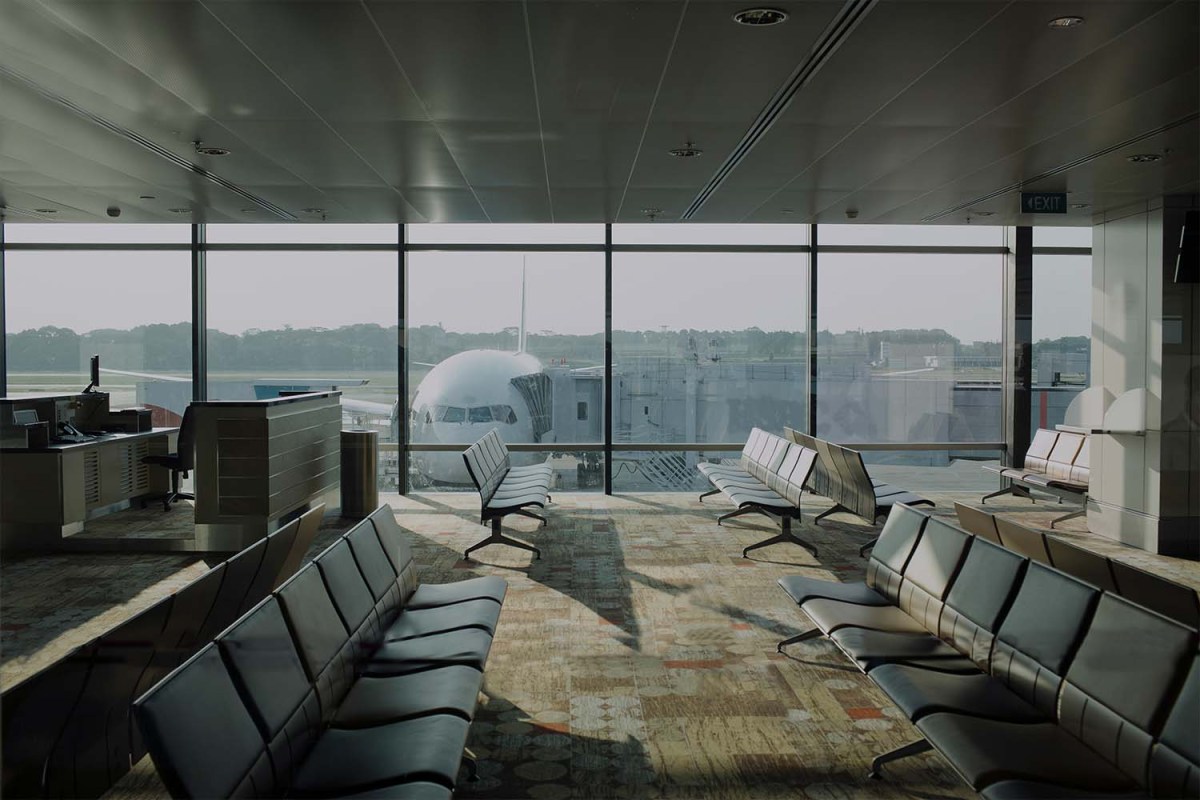 Empty airport lounge with plane outside