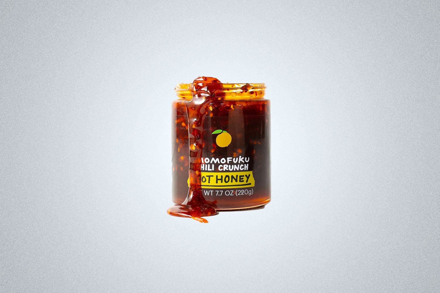 The Momofuku Chili Crunch Hot Honey on a gray background