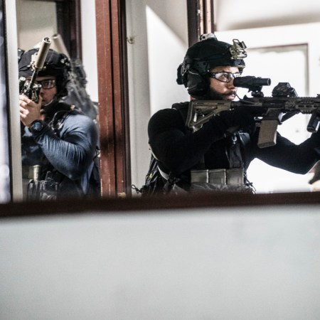 A still from the television show "SEAL Team," in which special ops forces enter a room with high-powered guns.