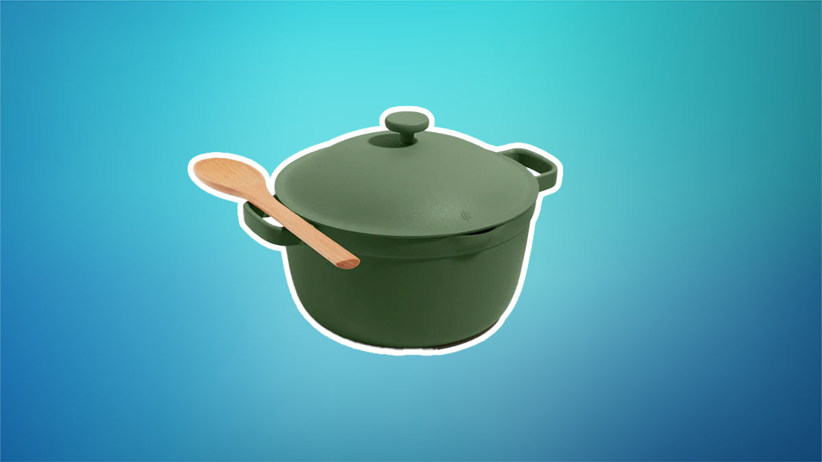 An Our Place Perfect Pot in green on a teal and blue background