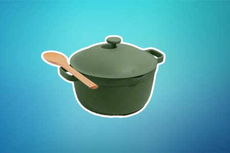 An Our Place Perfect Pot in green on a teal and blue background