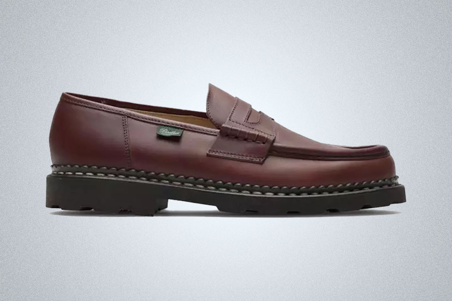 a brown Paraboot loafer on a grey background