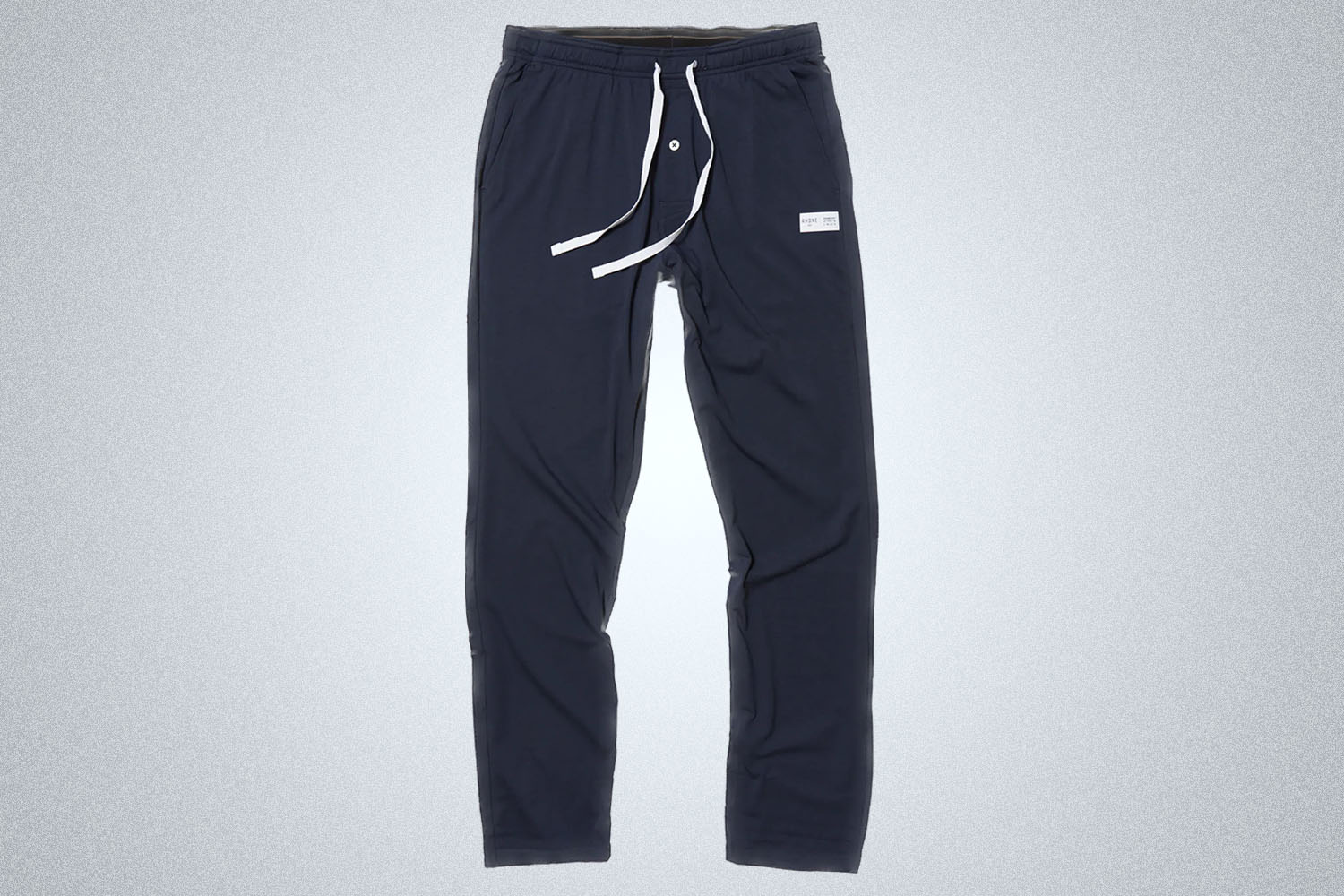 a pair of Rhone Element Lounge Pant on a grey background