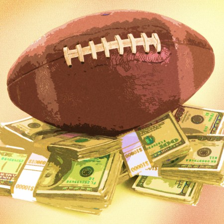 A football on stacks of money you could win in sports gambling