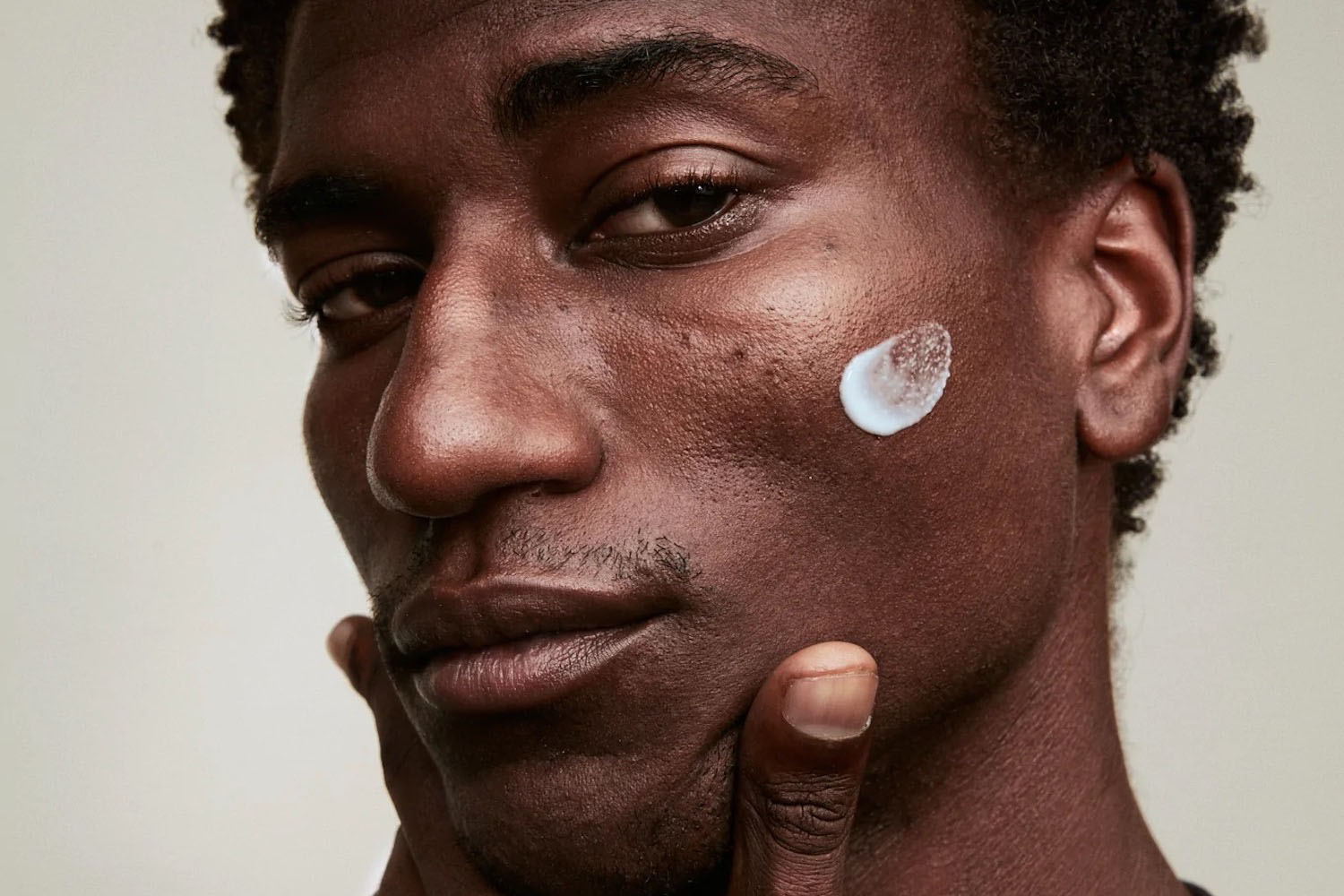 a model with Stratia Interface skincare on his face