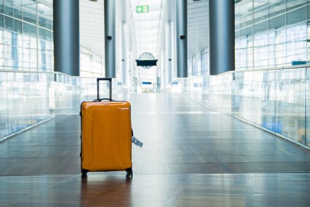 A yellow suitcase sits in the hall of an international airport. We take a look at the airports and airlines mishandling baggage in the U.S.
