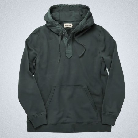 a green hoodie from Taylor Stitch on a grey background