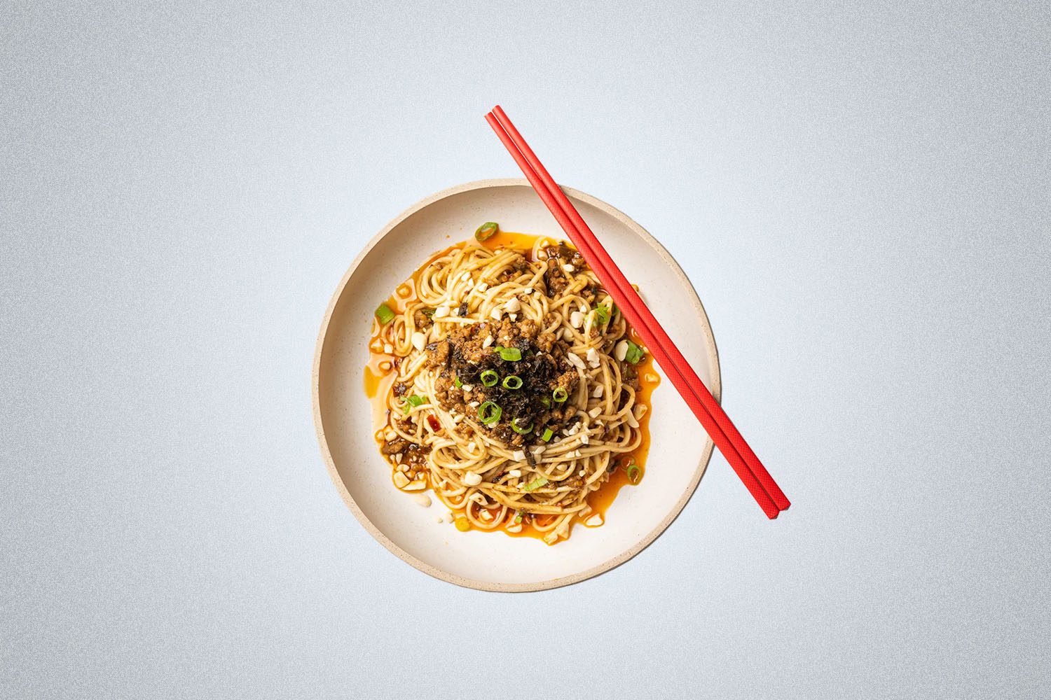 The XCJ Sichuan Dan Dan Noodle on a gray background