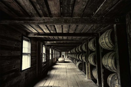 A warehouse with barrels holding booze. The location of the barrels in a warehouse can greatly alter flavor.