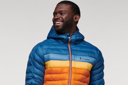 A man wearing Cotopaxi's Fuego Hooded Down Jacket, now on sale