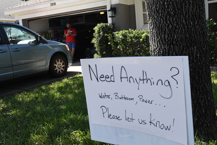 A sign on Chris Bartonâs lawn offers assistance to his neighbors whose homes were flooded by Hurricane Ian on October 1 in Orlando. We put together a list of volunteer opportunities for you to help, too.