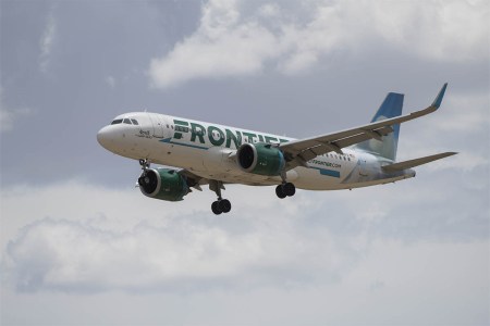 A Frontier Airlines flight prepares to land at Denver International Airport in Denver, Colorado, US, on Wednesday, June 29, 2022. Frontier will offer an unlimited travel plan in 2023 for select travelers