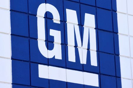 The General Motors logo in blue and white on a Chevrolet dealership. GM paused paid advertising on Twitter after Elon Musk's takeover of the social media platform.