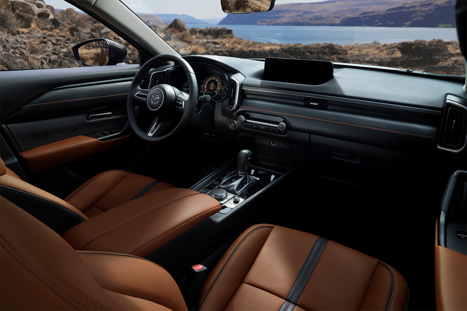 The interior of the Mazda CX-50 SUV, with brown seats and a digital display