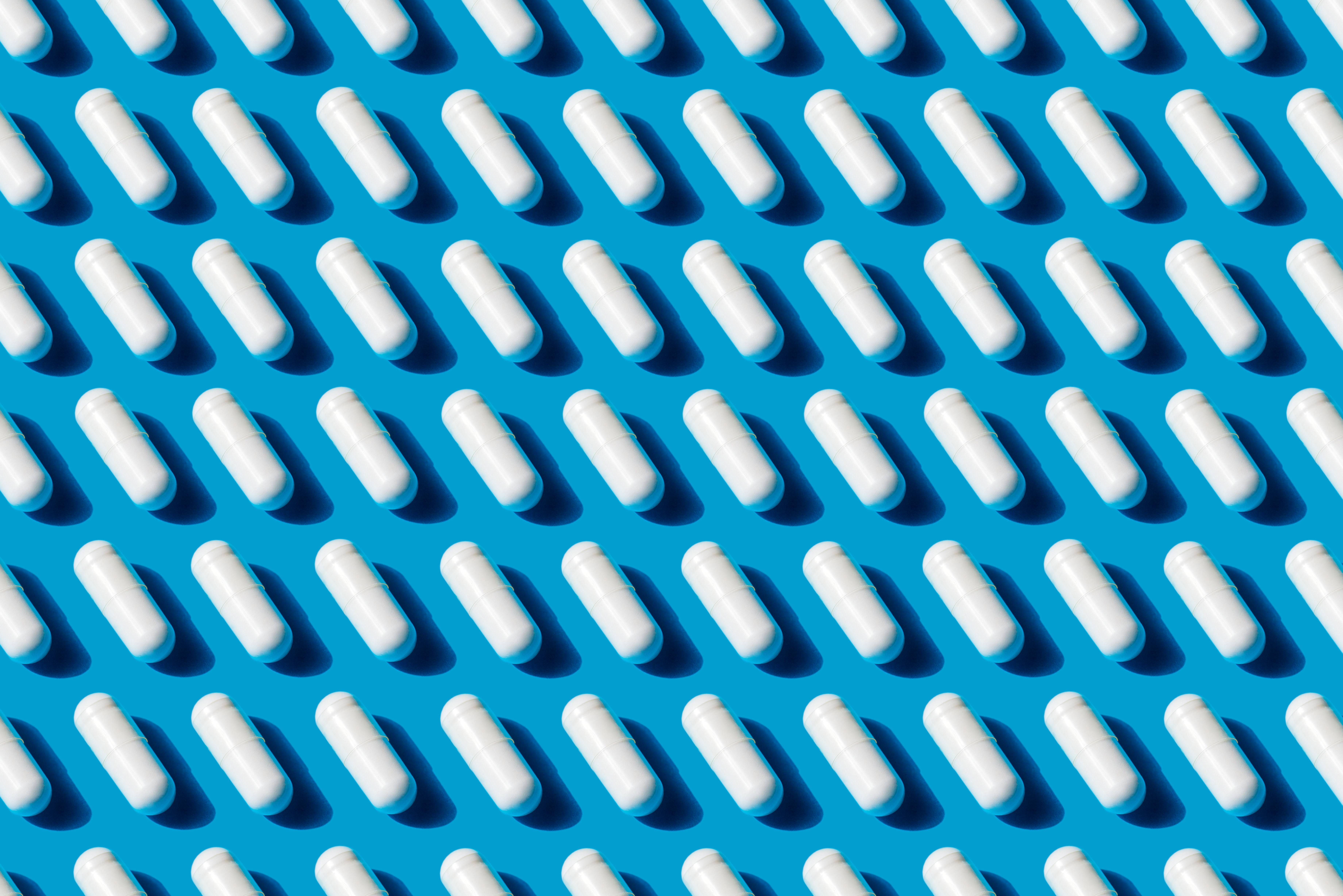 White capsules on a blue background.