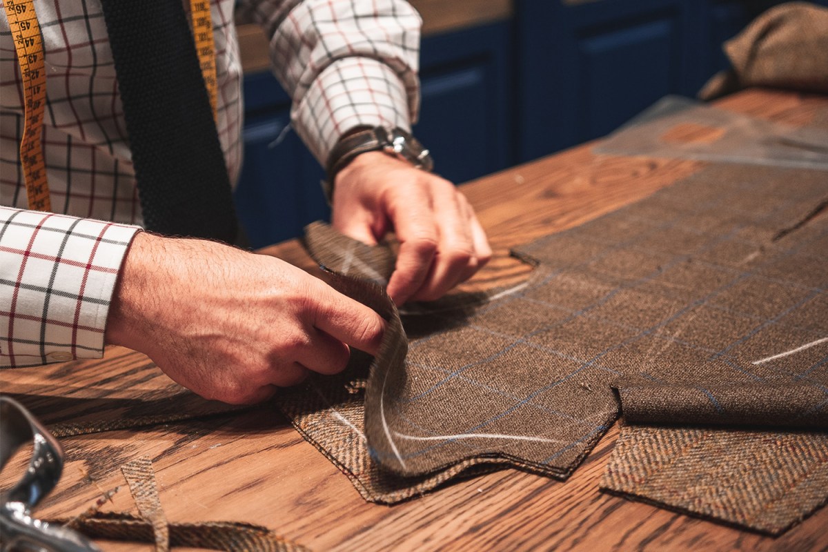Artisan tailor focused on hand stitching details