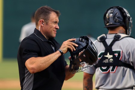 An umpire with a wire in his ear.