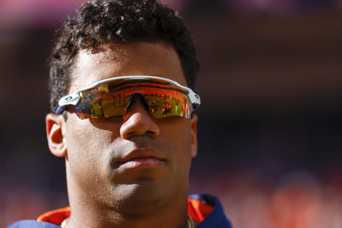 Russell Wilson of the Denver Broncos watches his team warm up.