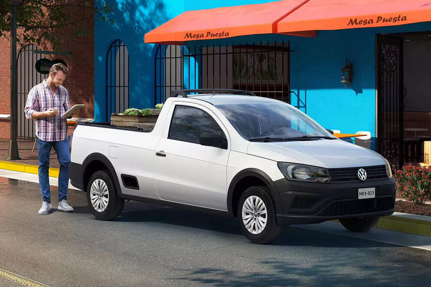 A man standing next to a white Volkswagen Saveiro, a compact pickup truck not available in the U.S.