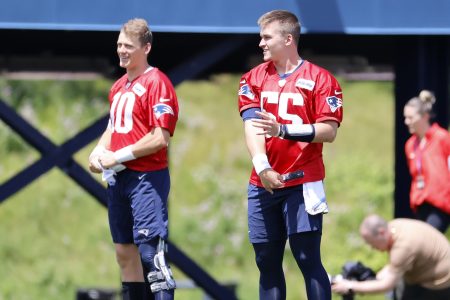 Patriots quarterbacks Mac Jones (10) and Bailey Zappe (55) warm up at minicamp.