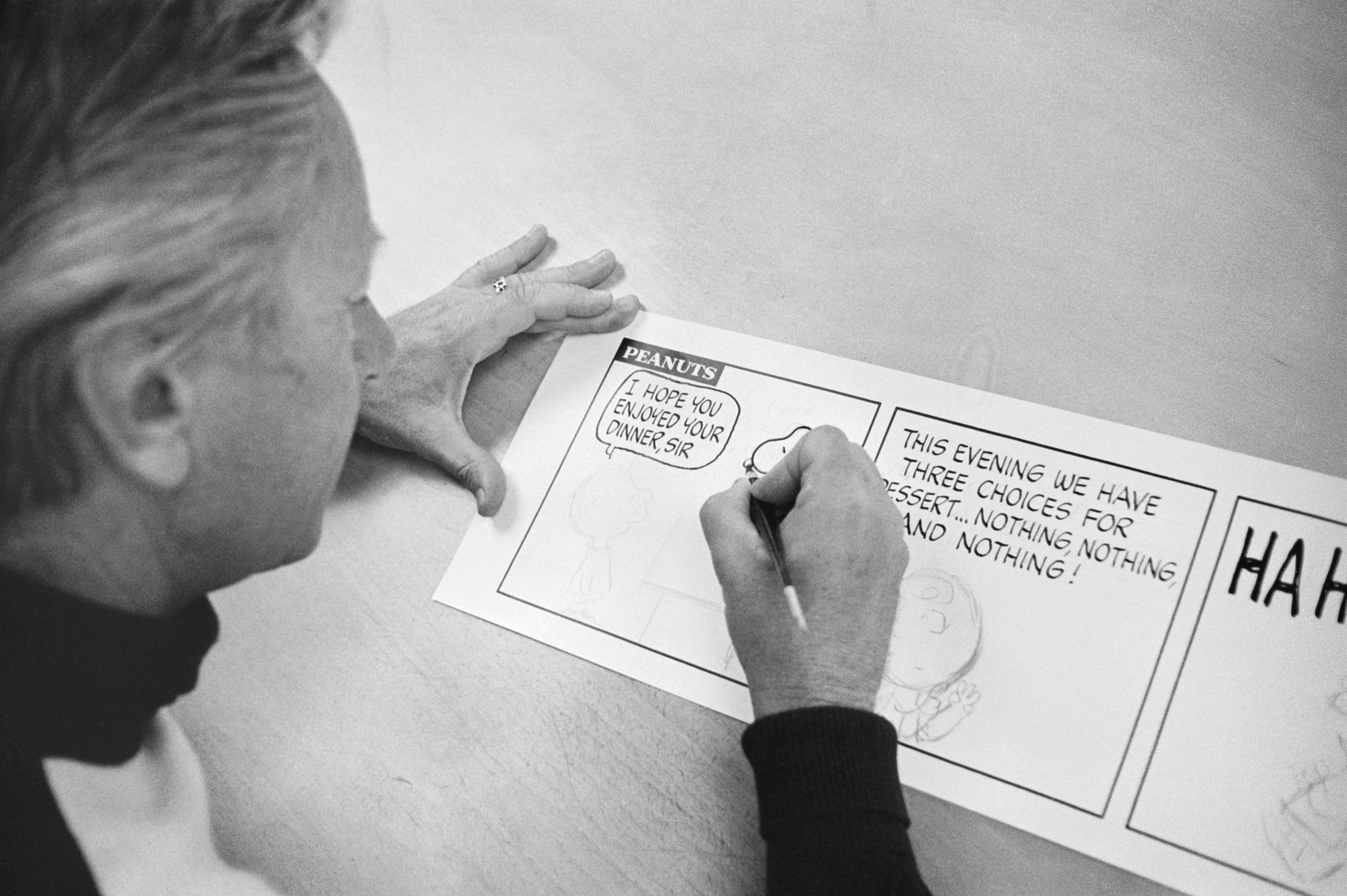 Charles Schultz showing the camera how to draw Snoopy.