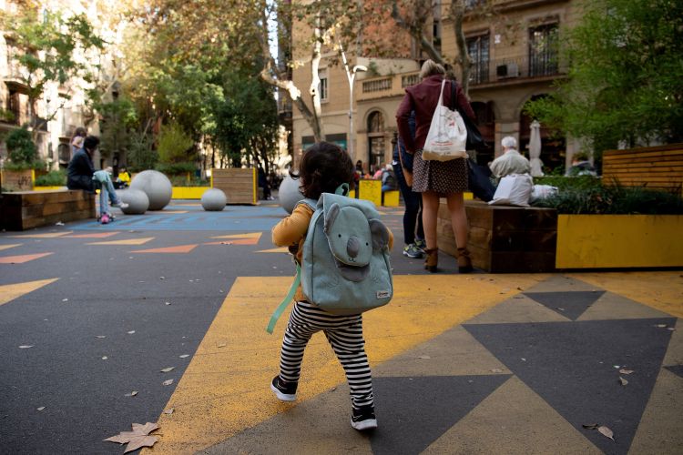 A child ambles through a "superilla" (superblock) plan promoting cycling and car-free zones in Barcelona. Could the concept work in the States?