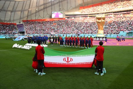 Representatives from Iran hold the national flag before a World Cup game against England.
