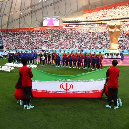 Representatives from Iran hold the national flag before a World Cup game against England.