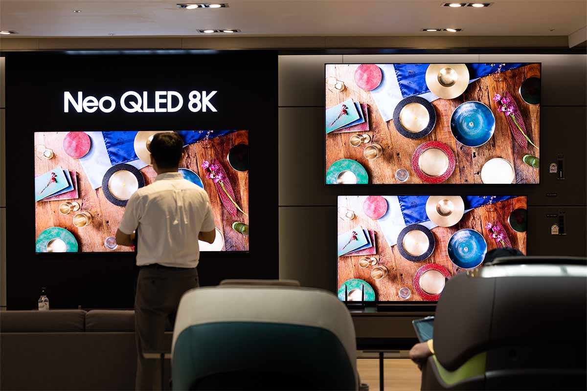 A customer looks at a Samsung Electronics Co. QLED 8K television at the company's D'light flagship store in Seoul, South Korea, on Tuesday, July 5, 2022. The energy consumed by 8K tvs is an issue in the European Union, which may effectively ban these sets starting in March.