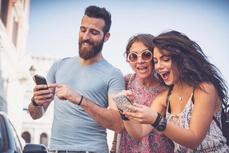 Friends placing bets on mobile phones