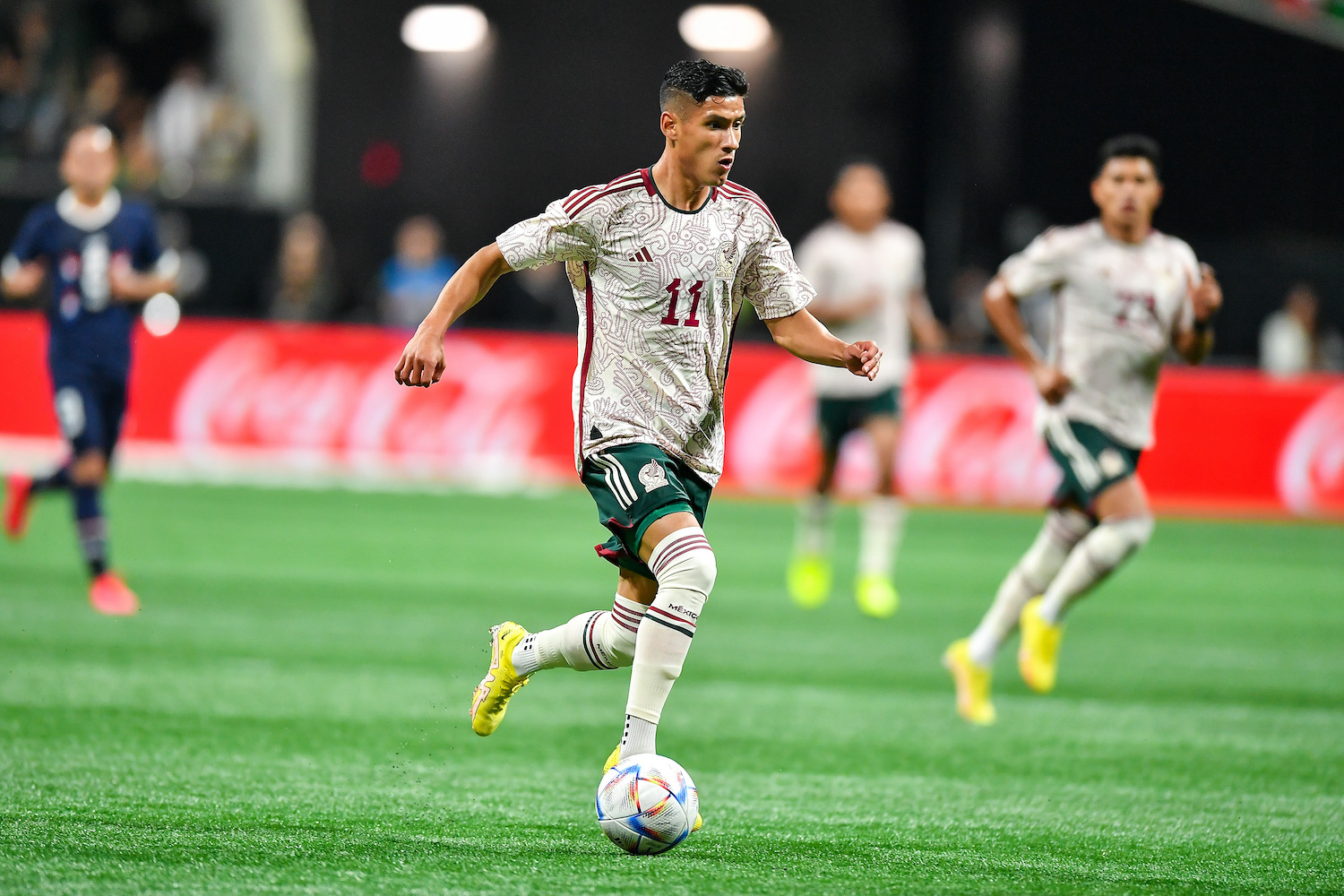 a soccer player for Mexico dribbling.
