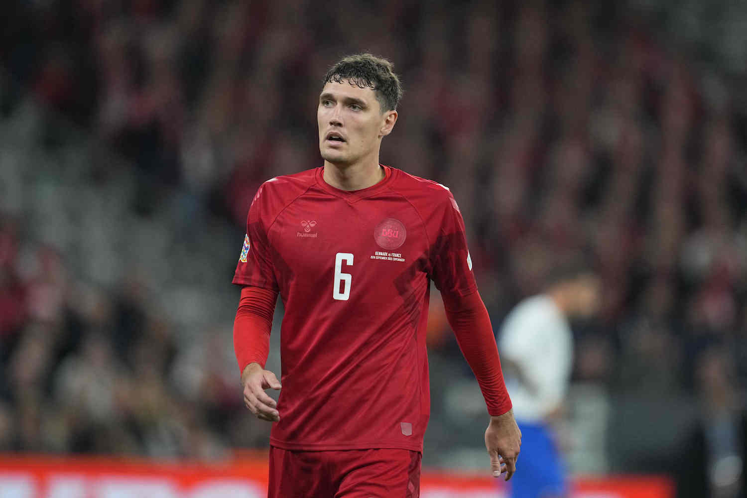 a danish soccer player in a red soccer jersey
