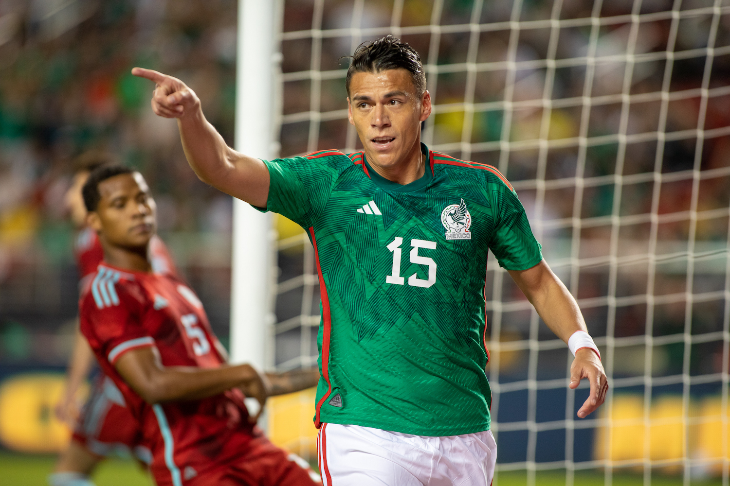 a mexican soccer player in a green jersey
