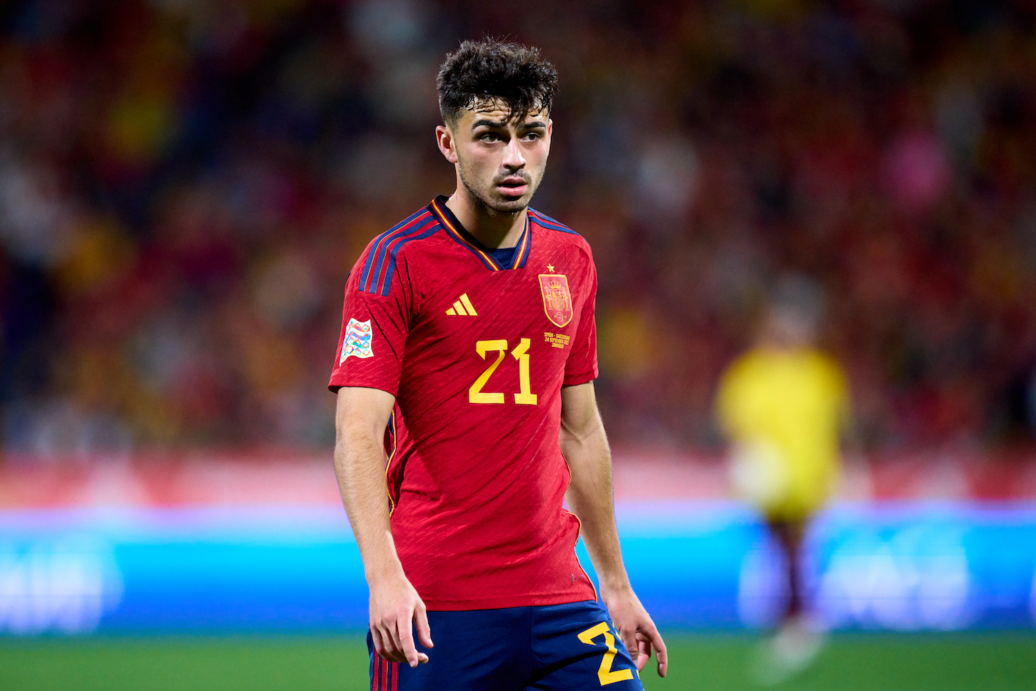 a spanish soccer player in a red jersey