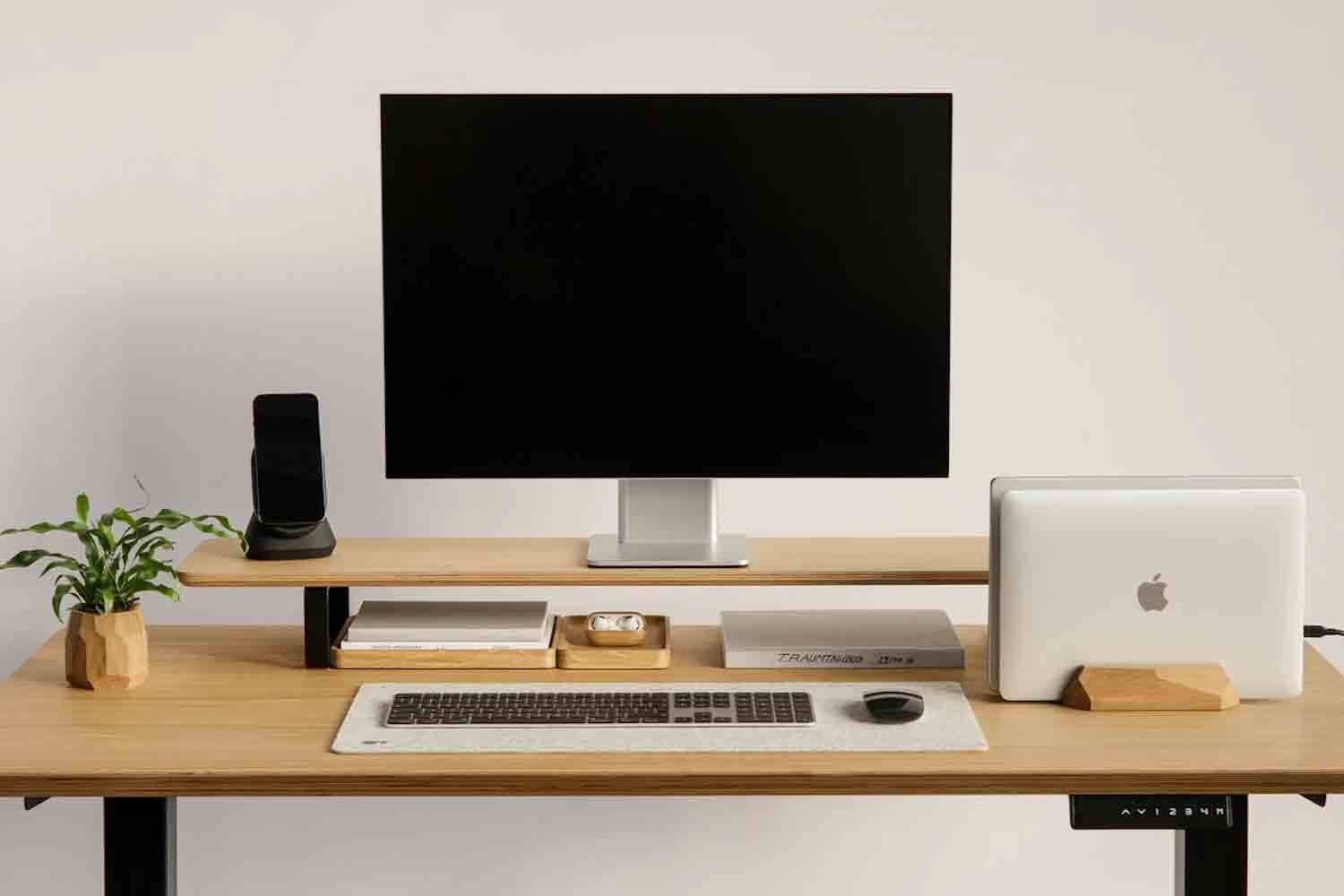 a desk with a variety of Oakywood Accesoreis and a laptop