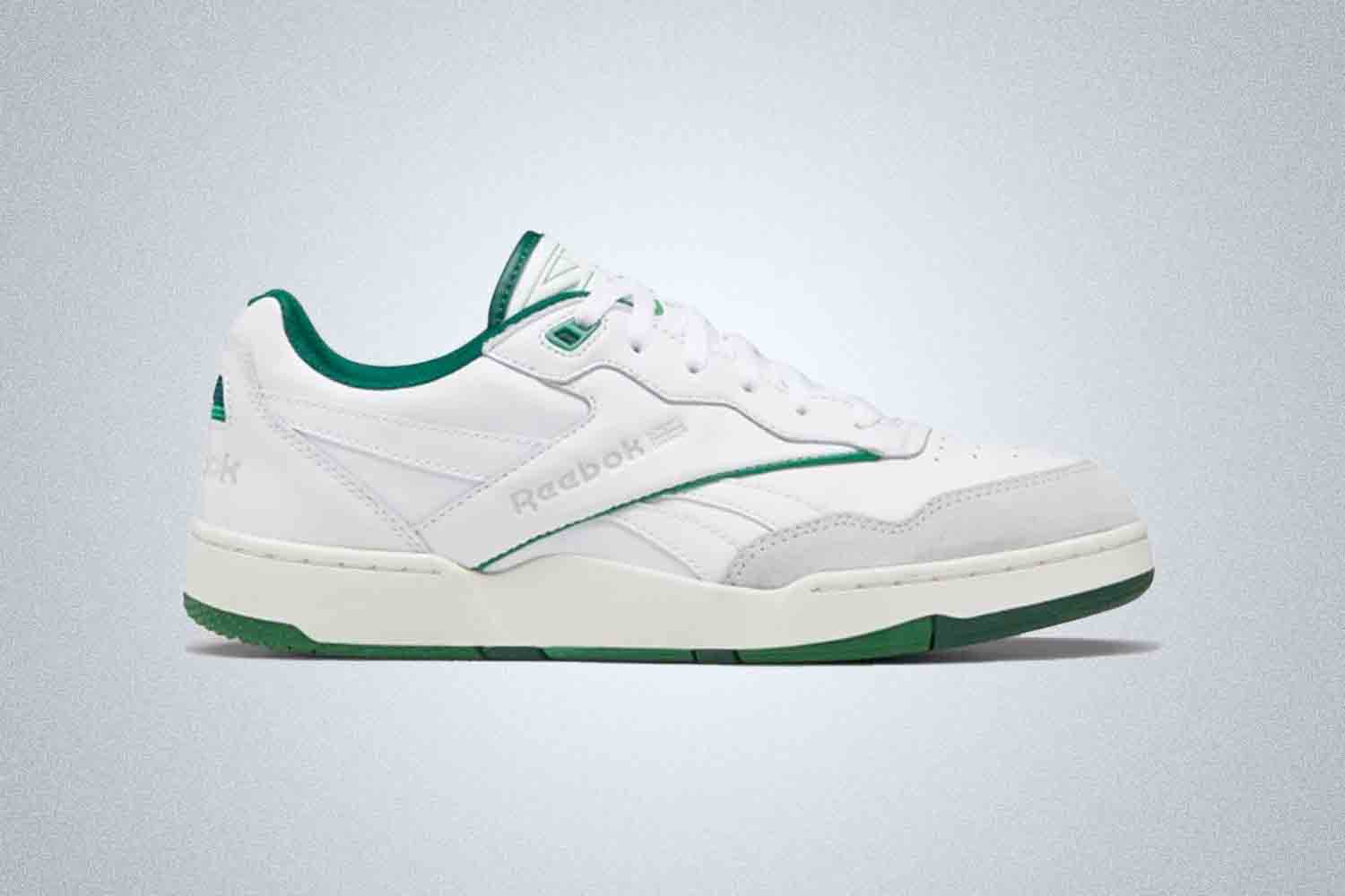 a green and white Reebok basketball sneaker on a grey background