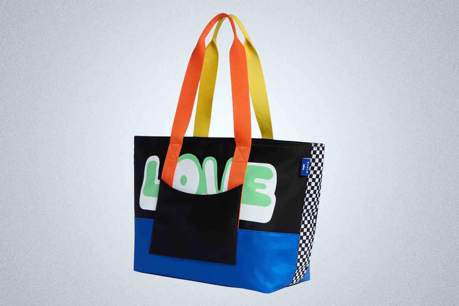 a multi-colored tote bag from STATE on a grey background